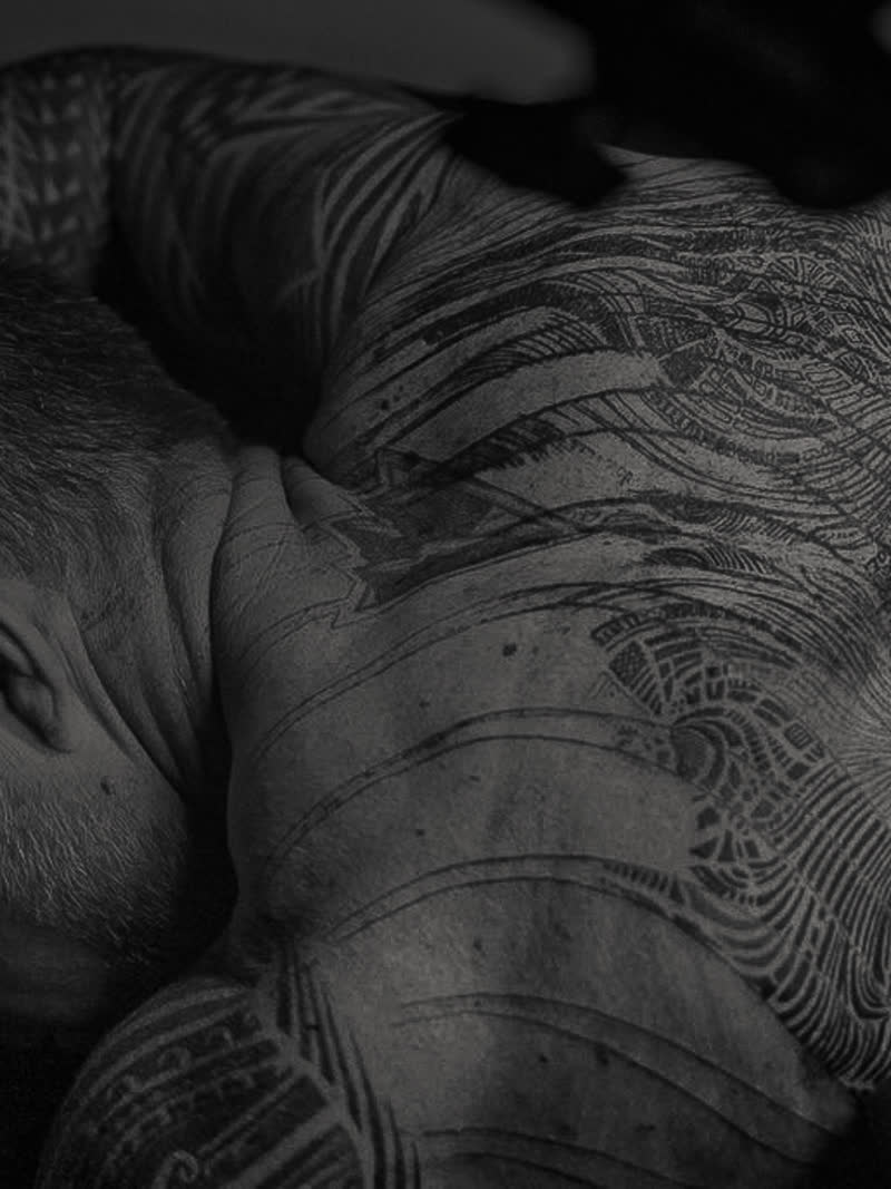 Dense blackwork linework across a back, Project Decay
