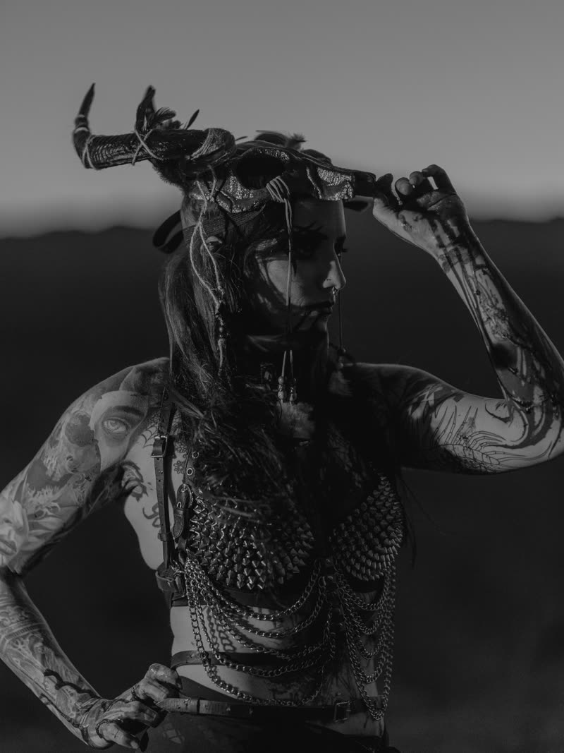 Horned figure in profile at dusk, chainmail catching the last light, black and white