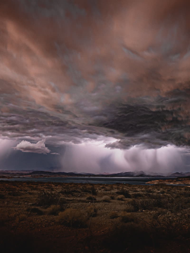 Lightning under a bruised sky, panoramic across the valley