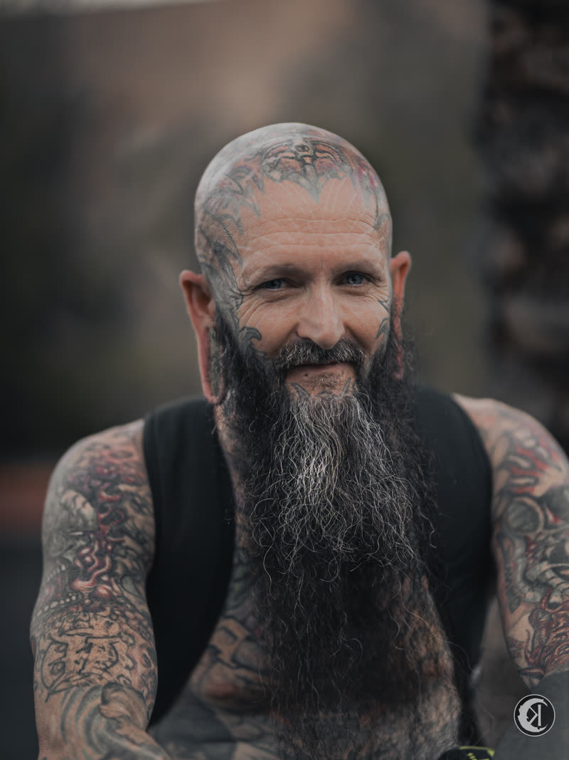 Tattooed portrait, grey beard, straight to camera