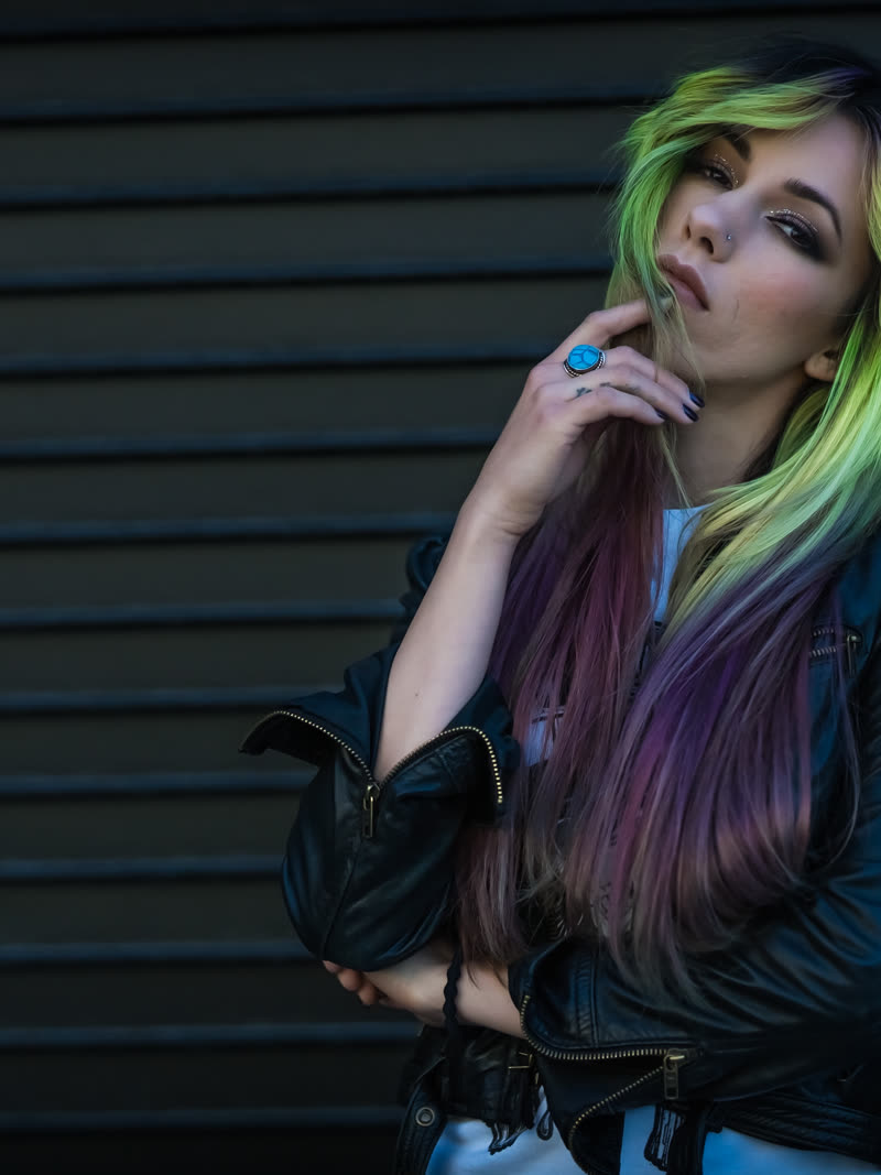 Green hair against a steel roller shutter