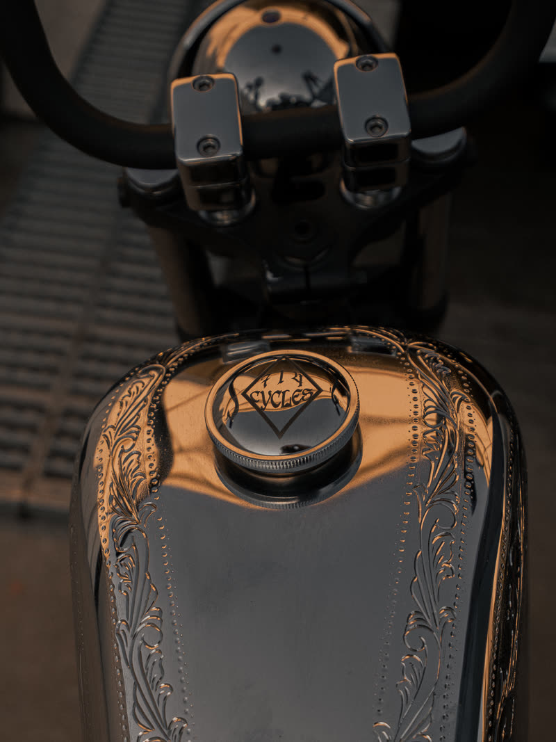Gold and chrome engraving across the tank and filler cap