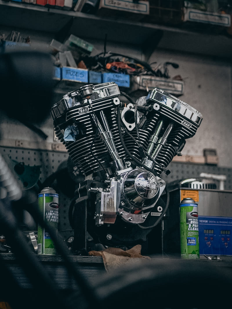 A V-twin engine up on the bench in the shop