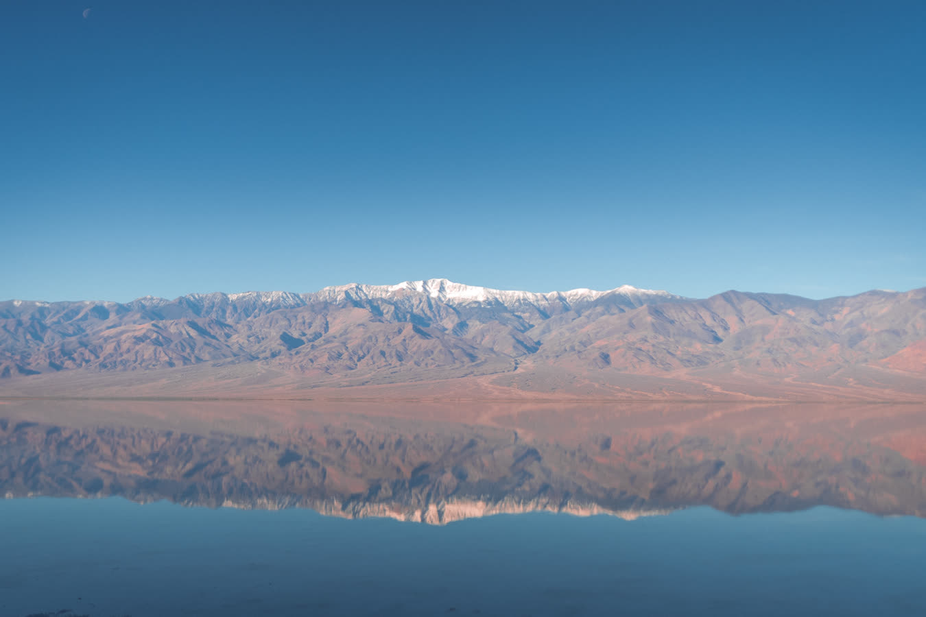 Blue hour on the flooded flats, the range doubled in still water