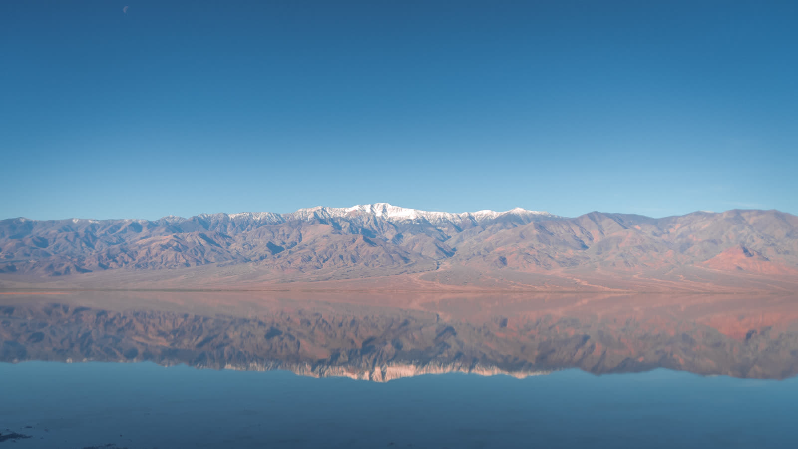 Blue hour on the flooded flats, the range doubled in still water