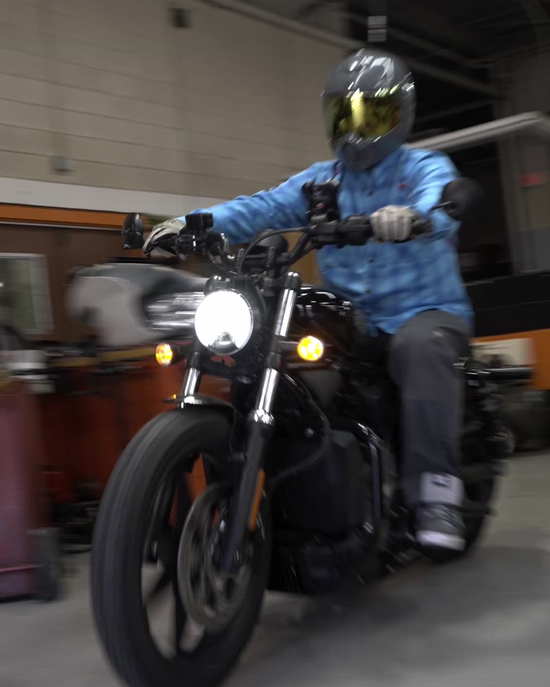 Rider on the bike inside the shop, helmet on