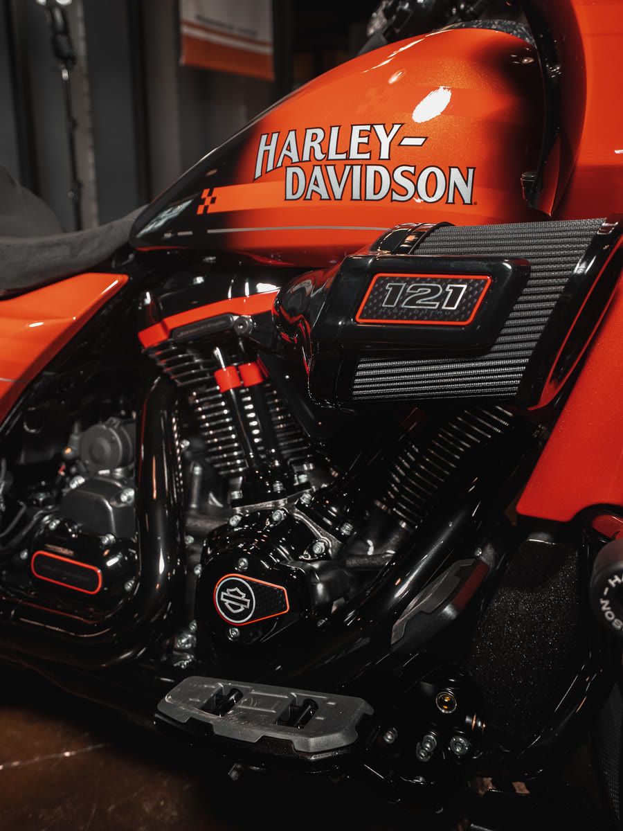 The 121 badge on the orange Road Glide engine