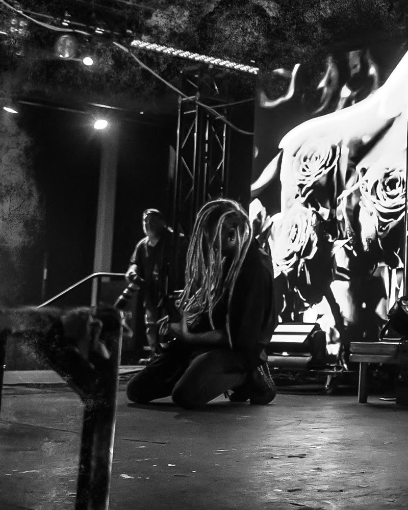 Crouched at the edge of the stage