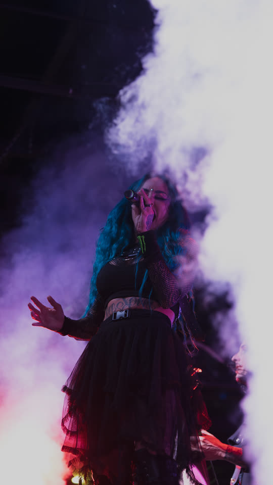Stitched Up Heart vocalist in violet smoke