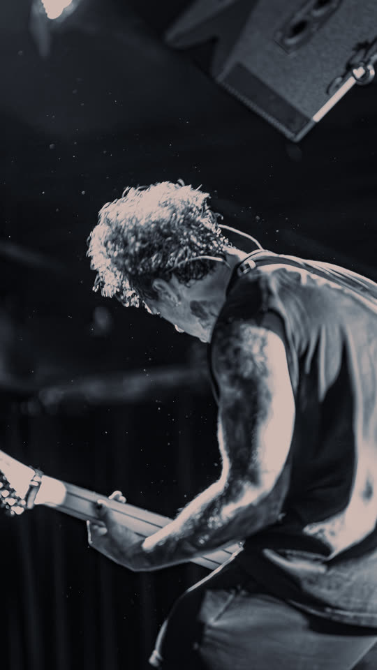 Guitarist bent over the neck