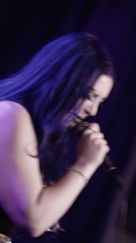 Vocalist head down over the mic stand