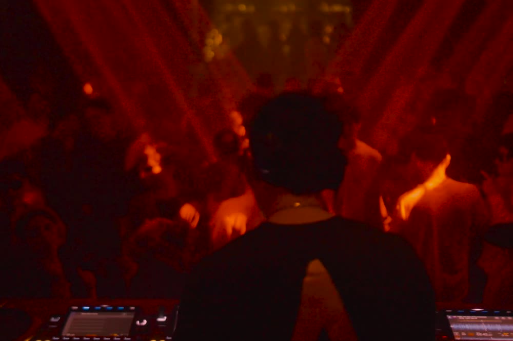 Behind the DJ, looking out over the floor