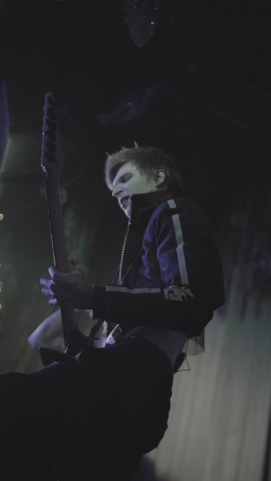 Vocalist in the dark at the edge of the stage