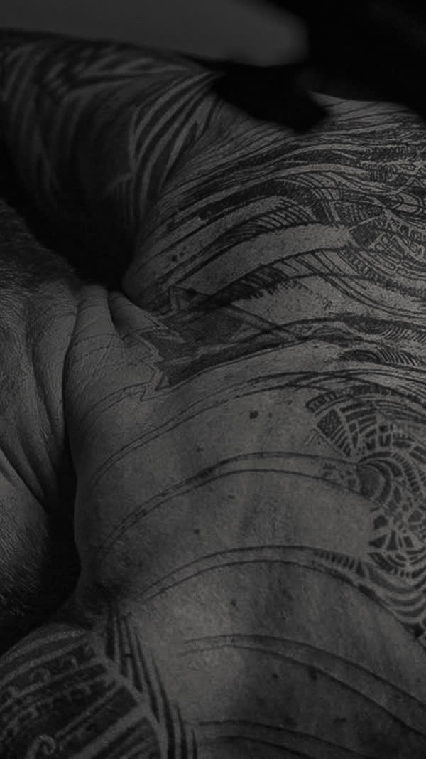 Dense blackwork linework across a back, Project Decay