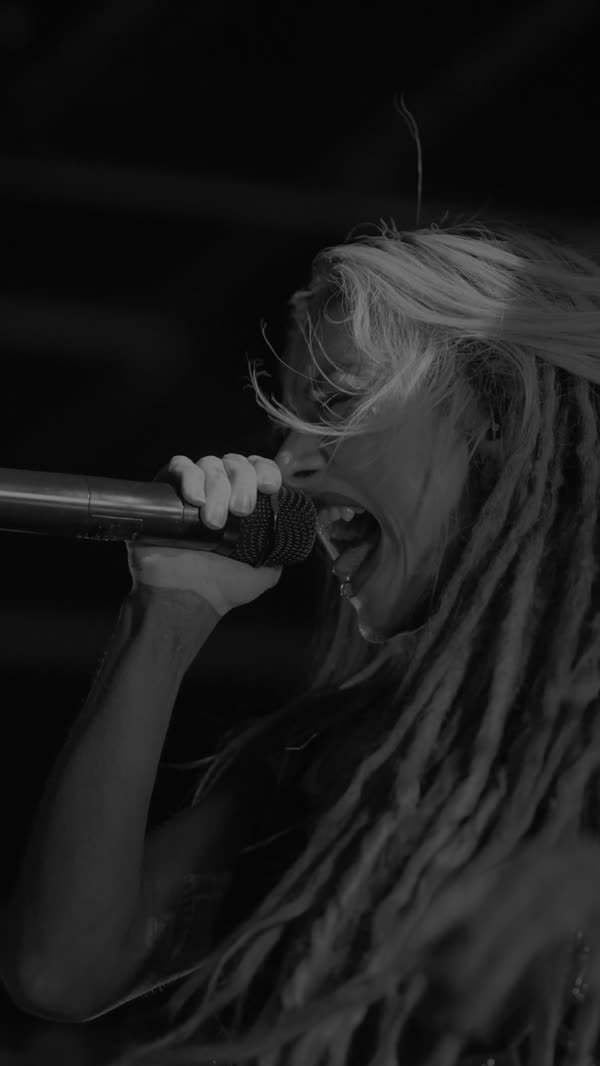 Infected Rain vocalist mid-set under hard white light