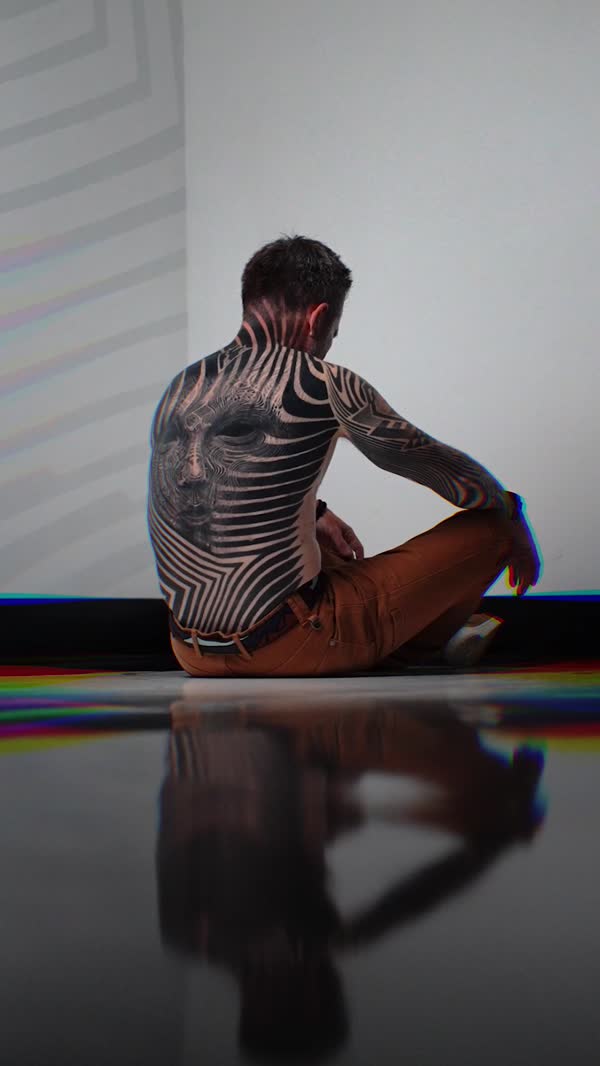 Tattoo artist mid-session at the Golden State Expo